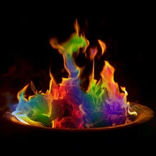 Close-up view of vibrant rainbow colored flames dancing in a dark outdoor fire pit detail