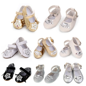 Flat lay collection of doll shoes featuring glitter PU leather and rhinestone flower buckles