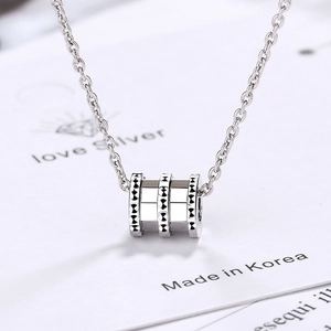 Elegant silver necklace featuring three textured ring pendants in minimalist style