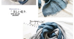 Detail of grey and blue linen scarf showing natural fabric texture and fringe edges