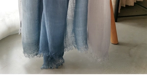 Close-up of blue to purple gradient linen scarf featuring delicate fringe edge details