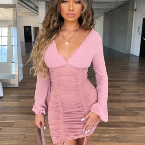 Detail of pink bodycon dress with sheer mesh long sleeves and pleated drawstring design