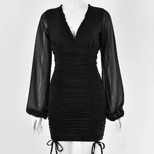 Detail of black V-neck mini dress with ruffle trim, sheer long sleeves and side drawstrings