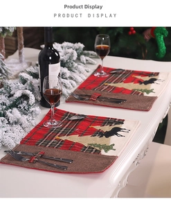 Detail of red plaid Christmas placemat with cutlery pocket and embroidered reindeer