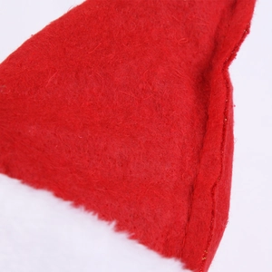 Close-up of thick red felt fabric and white plush trim on a festive Christmas hat