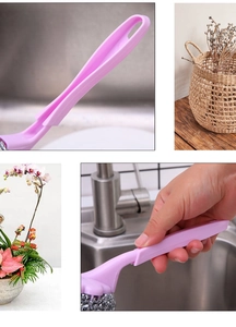 Macro shot of pink ergonomic long handle and stainless steel scouring ball for dish cleaning