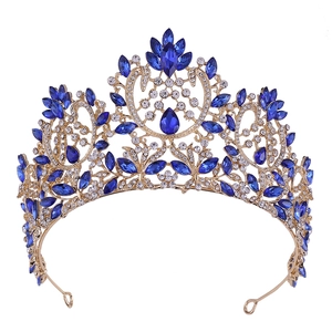 Detailed macro view of luxury baroque golden crown with blue crystals and rhinestones