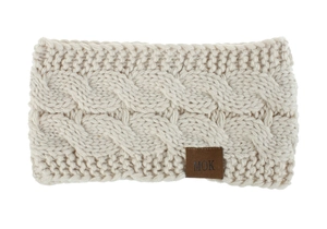 Detail of cream cable knit winter headband showing thick yarn texture and leather logo tag