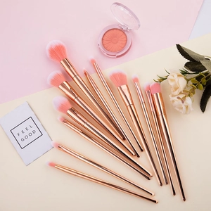 Close-up of 12-piece rose gold makeup brush set with pink gradient soft bristles