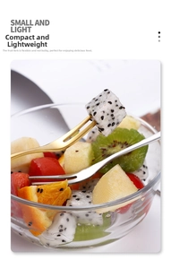 Close-up of small 304 stainless steel gold and silver fruit forks with a glass dessert bowl