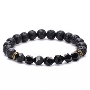 Detail of faceted black beads and porous lava stone bracelet with bronze spacers