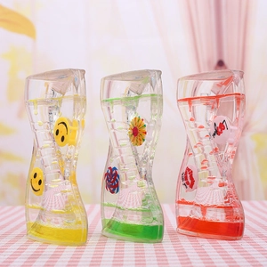 Detailed view of three colorful oil liquid timers with spinning wheels on pink background