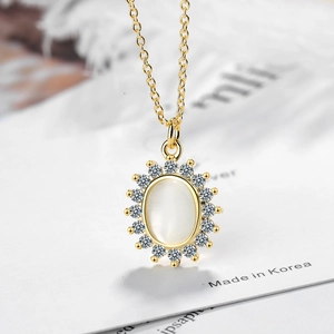 Elegant gold flower necklace featuring a white opal pendant surrounded by sparkling zircons