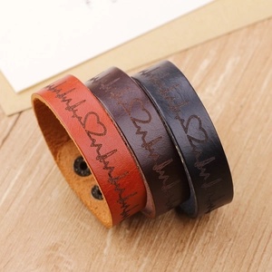 Trois bracelets vintage en cuir avec motif ECG et boutons-pression en noir et marron