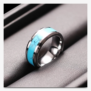 Detail of 8mm stainless steel ring with polished finish and turquoise inlay