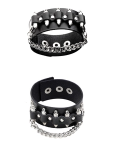 Detail of punk black leather wristband with silver metal spikes and chunky chain links