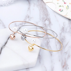 Three-piece stainless steel open bangles set in rose gold, silver, and gold with pearls
