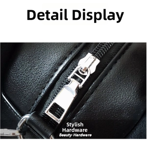 Macro shot of silver metal zipper and hardware on black pebble leather guitar bag