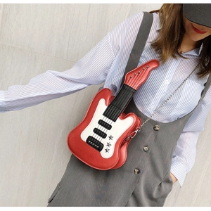 Detail of creative guitar-shaped shoulder bag in vibrant red PU leather with chain