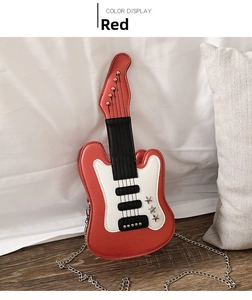 Detail of red electric guitar shaped crossbody bag with silver stars and chain strap