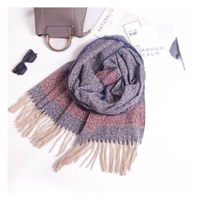 Detail view of thick striped scarf with long fringes, navy and orange knit texture