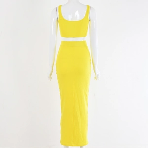 Detail of yellow ribbed knit two-piece set featuring backless crop top and long pencil skirt