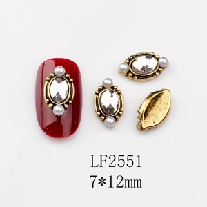 Detail of vintage gold nail charms with oval crystal and white pearls, 7x12mm size