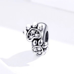 Macro detail of S925 sterling silver pet paw charm with shimmering zircon inlay