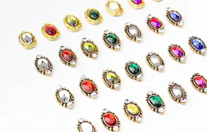 Detailed flat lay of vintage alloy nail art jewels with colorful stones and metal borders