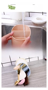 Close-up of a double-layer plastic drainer rack for utensils showing drainage holes
