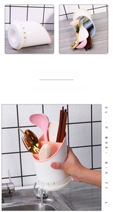 Macro detail of detachable pink drainage tray and interior grid of the utensil holder