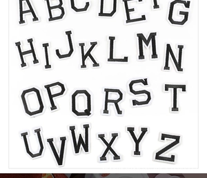 Detailed view of 26 black and white embroidered alphabet letter patches for school uniforms