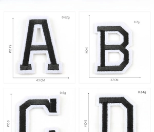 Detail view of black and white embroidered letter patches with dimensions and weight