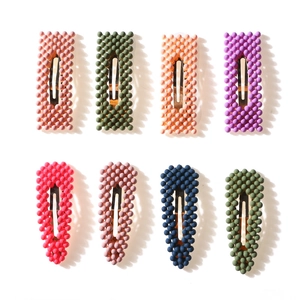 Colorful matte pearl hair clips in rectangular and teardrop shapes on white background