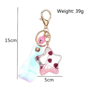Star-shaped acrylic keychain with pink sequins, liquid quicksand, and laser leather strap