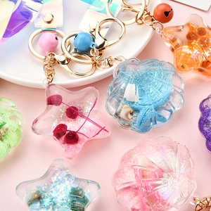 Sparkly acrylic liquid keychain with starfish and shells in various pastel colors