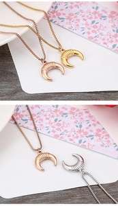 Detailed view of crescent moon pendants in gold, rose gold and silver on box chains