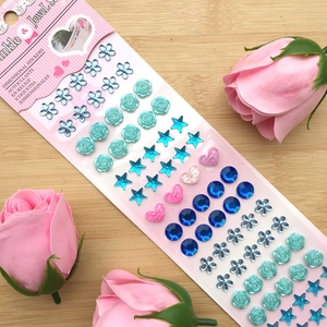 Macro detail of colorful dimensional crystal gem stickers in heart and star shapes