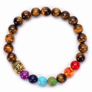 Detailed shot of chakra tiger eye stone bracelet with golden buddha head on white background