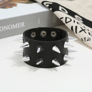 Close-up of black punk leather bracelet featuring two rows of silver cone metal rivets