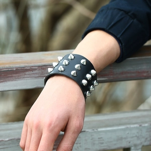 Punk style faux leather wristband featuring three rows of silver metal cone spikes