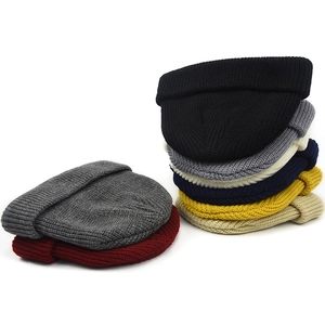 Short retro docker cap in various colors featuring premium knit texture and rolled edge