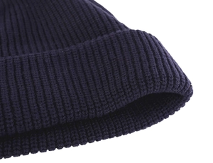 Detailed macro view of the navy blue ribbed knit pattern on the beanie cuff