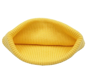 Detailed view of the ribbed knit texture and inner folding of the yellow beanie cap