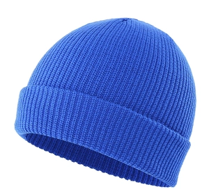 Detailed view of the vertical rib knit texture on a blue winter beanie cap