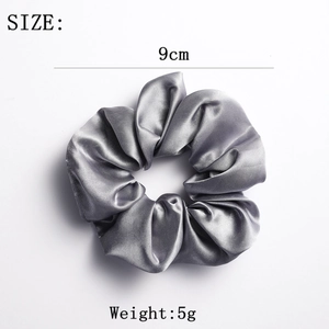 Detail of a 9cm grey satin scrunchie showing smooth texture and high-quality shine