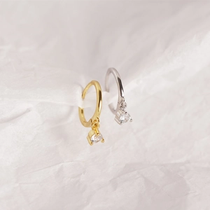 Close-up of gold and silver S925 sterling silver hoop earrings with clear zircon stones