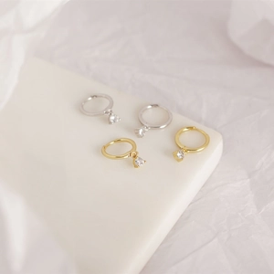 Detailed view of S925 sterling silver hoop earrings with cubic zirconia in gold and silver