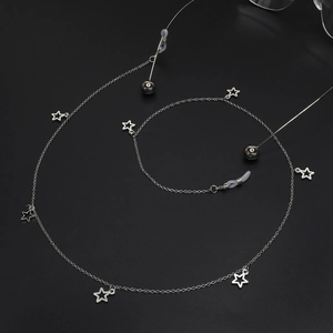 Silver star charm eyewear chain with anti-slip silicone loops on black background