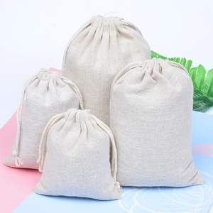 Set of four beige linen drawstring bags in various sizes with natural cotton cords
